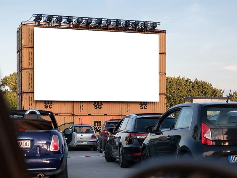 Cars lined up under the evening sky at the Beacon Drive-In Theatre near Seward Oklahoma, ready for a night of outdoor movies