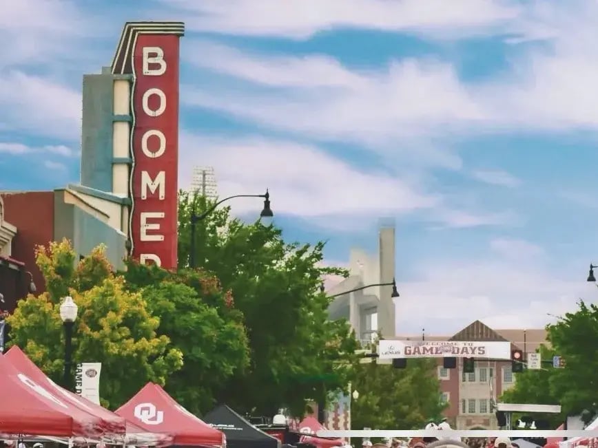 Street view with OU-themed tents during an event.